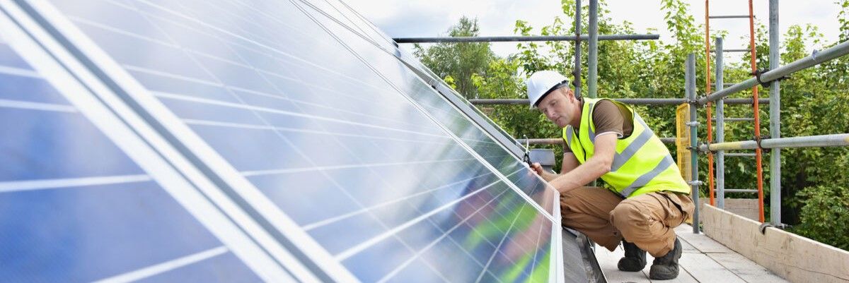 Worker fitting solar panels