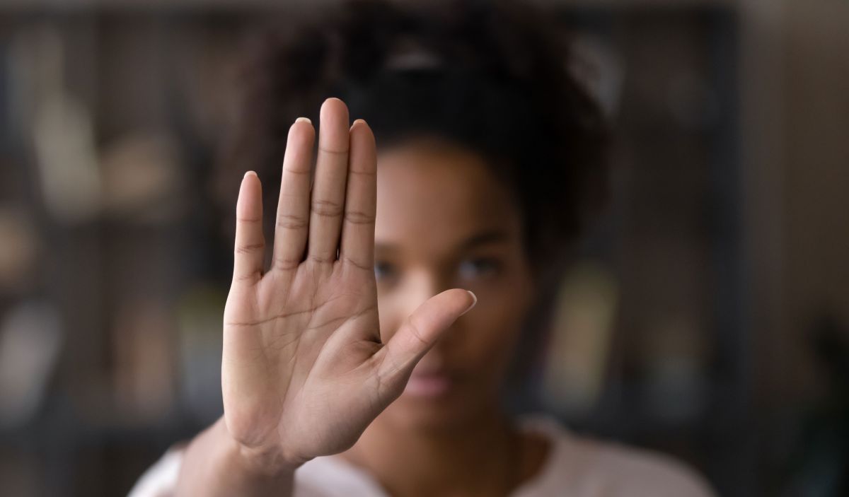 woman raising hand to say no