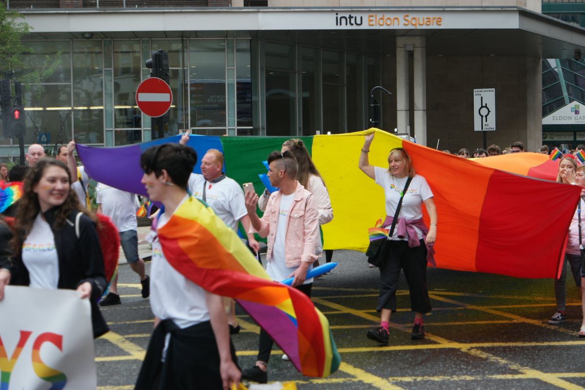 Photo of marchers with giant pride flag in Newcastle