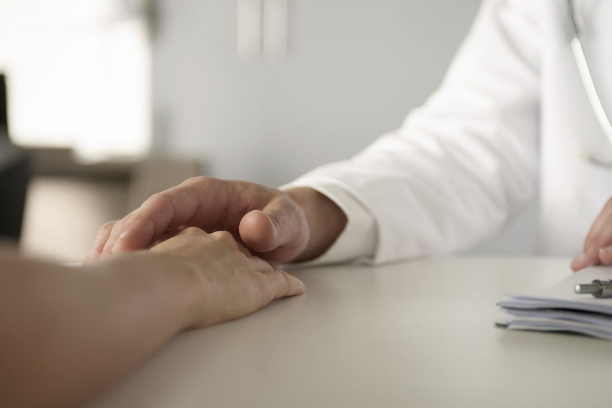 Two hands touching in an office