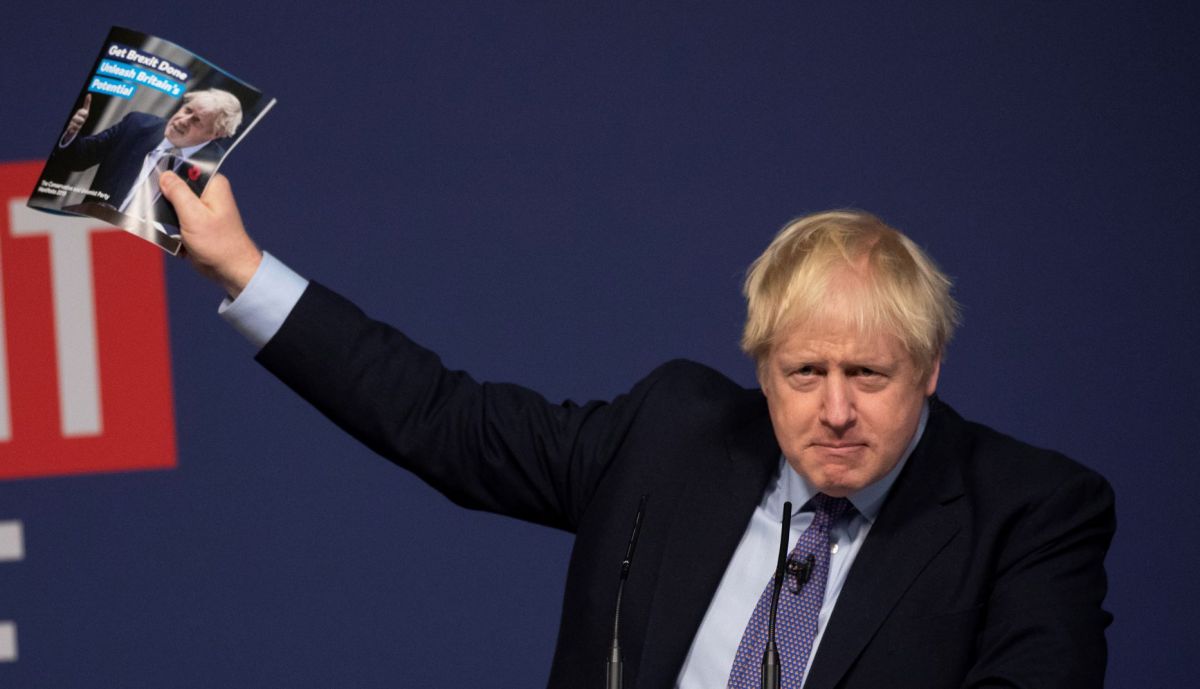 Boris Johnson holds up the 2019 Conservative manifesto