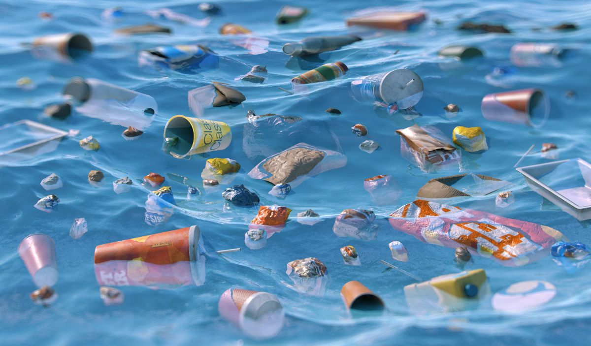 Ocean pollution. A sea surface littered with plastic bottles, debris, bags, food packaging