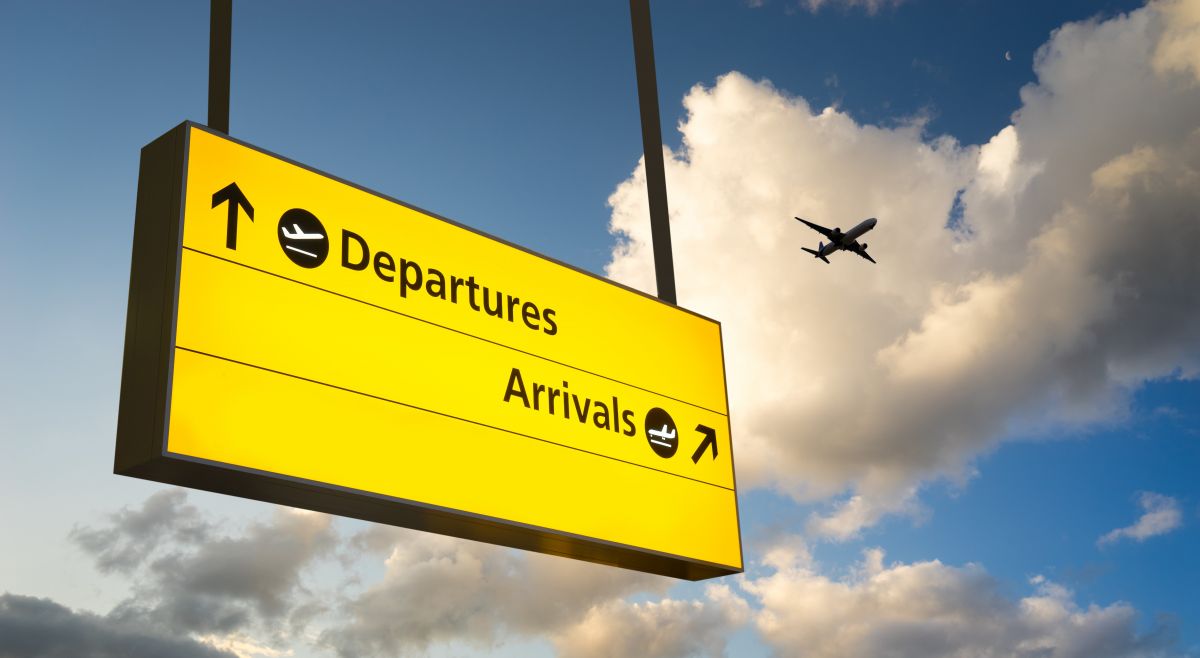 an airport sign showing arrivals and departures
