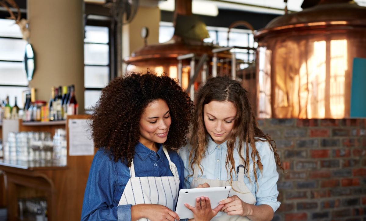 Young waitresses look at a tablet