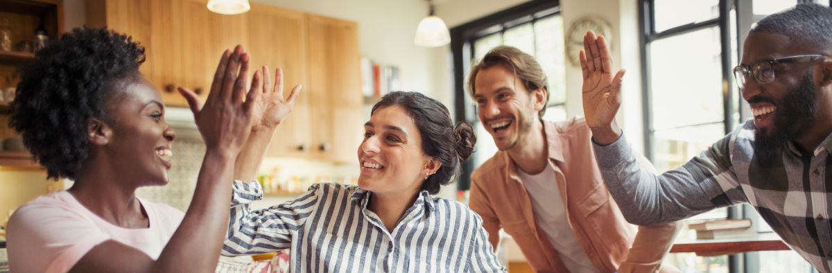 Creative business people high-fiving in meeting