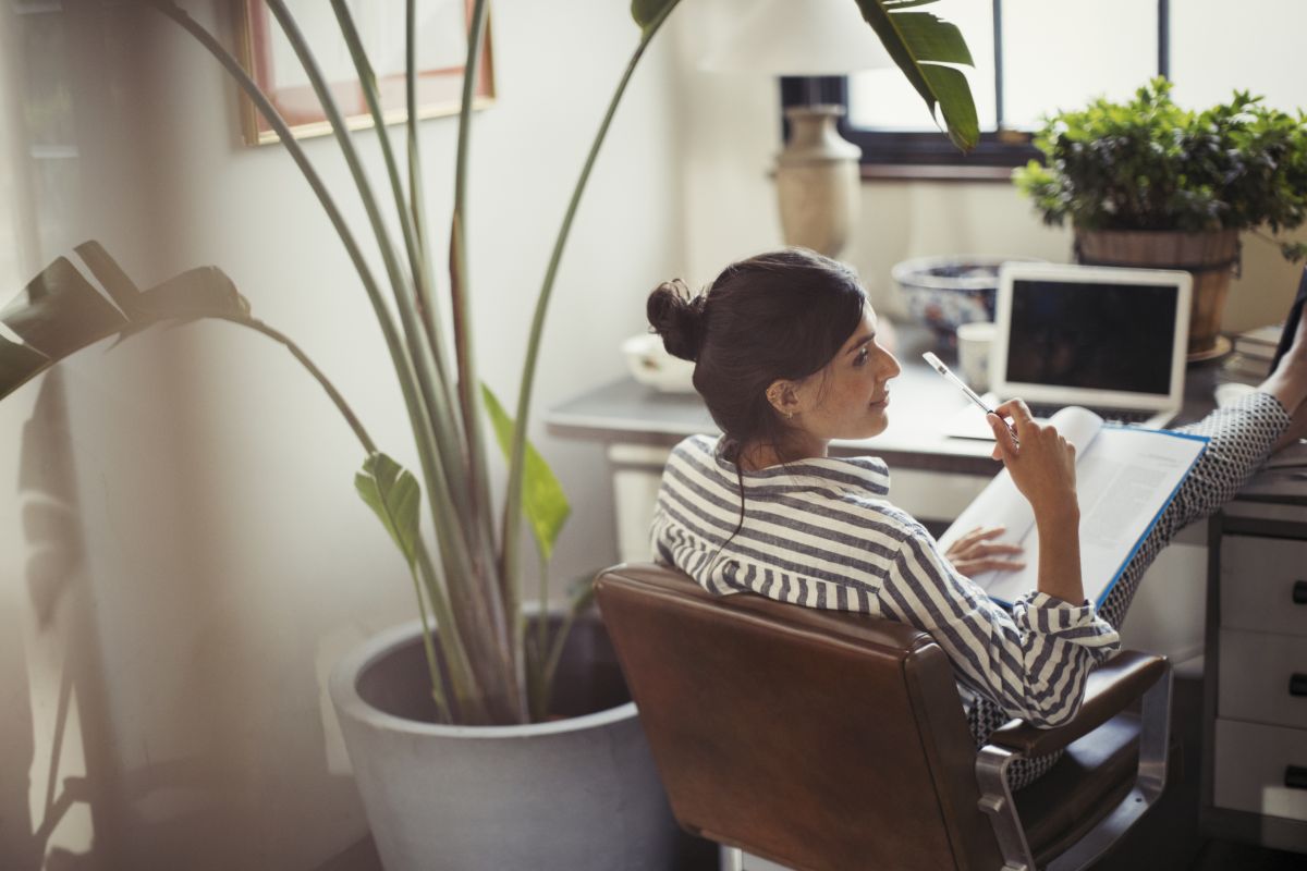 A woman working at a desk in her home