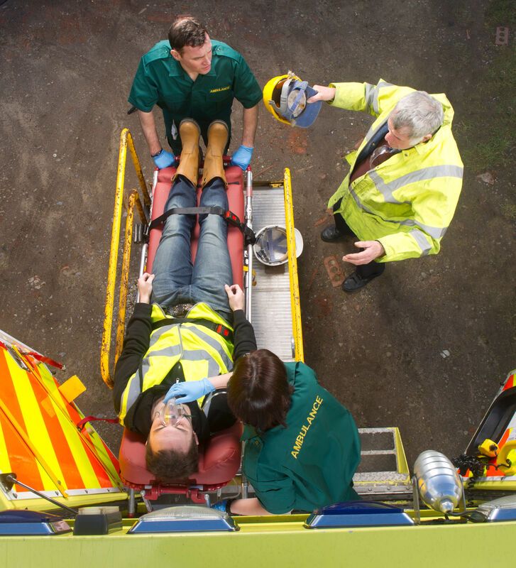Worker laying down on stretcher 