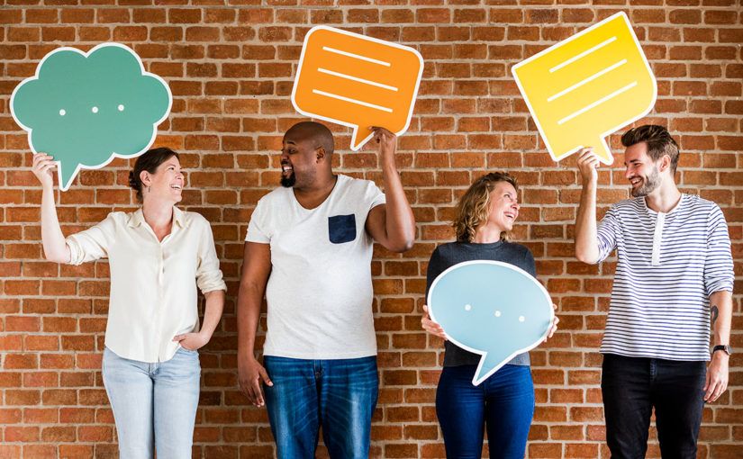 Four people holding speech bubbles