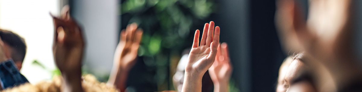 group of raised hands