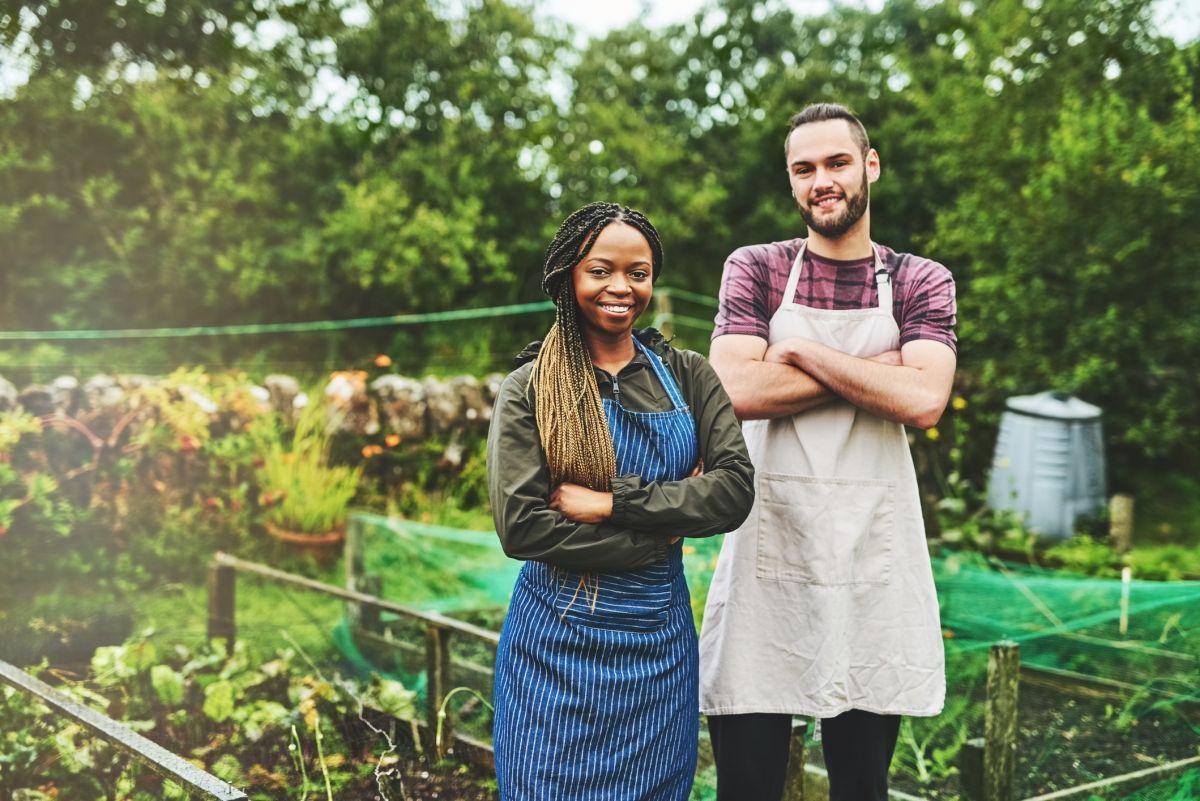 Image of workers standing in garden with green background