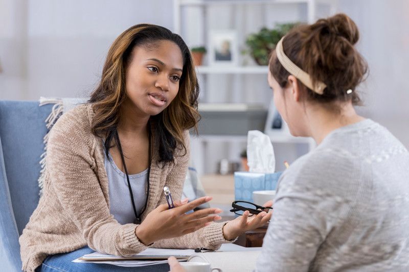 Two female young workers talking 