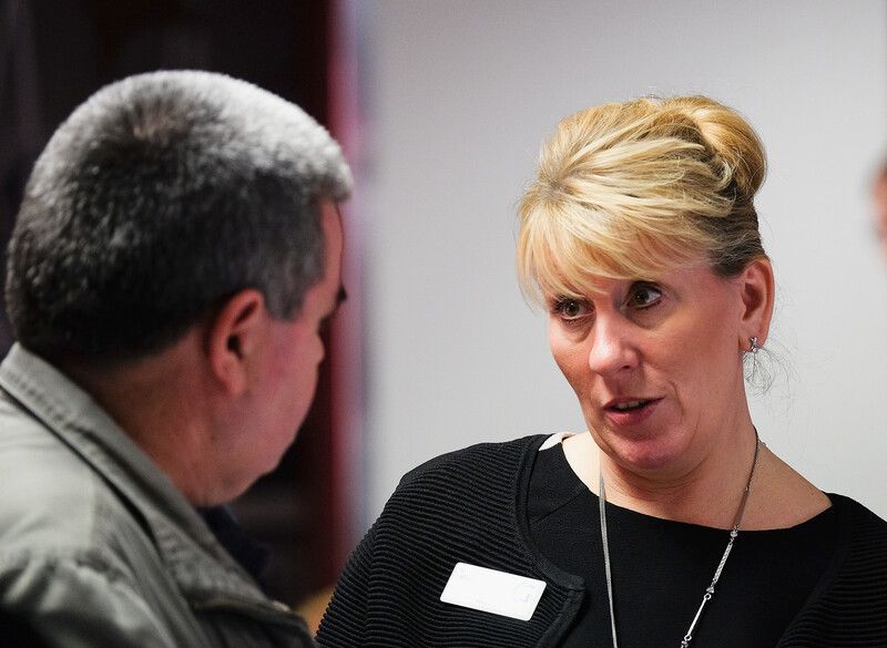 A female and a male colleague talking face to face