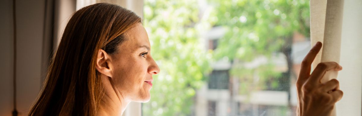 woman looking through window