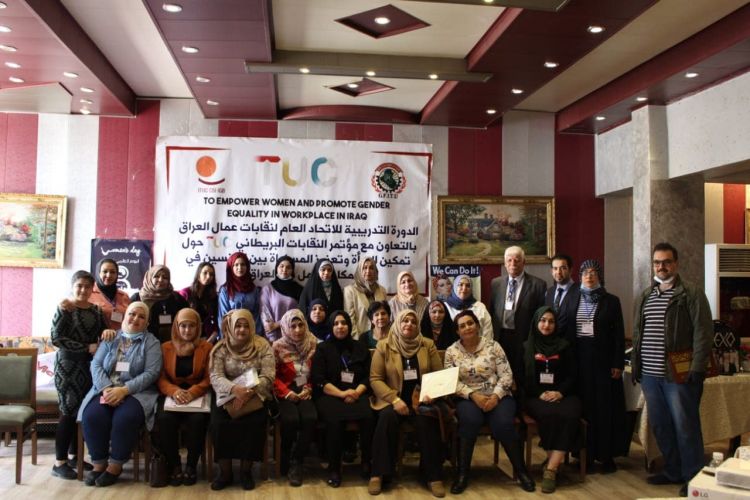workshop in Iraq, group of people in front of tuc banner