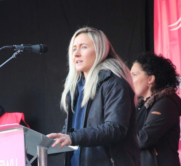 amy ash speaking at a podium