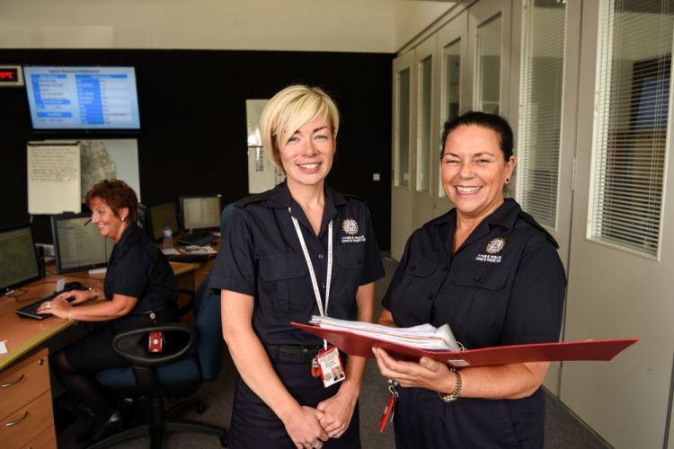 Two female public service workers smiling
