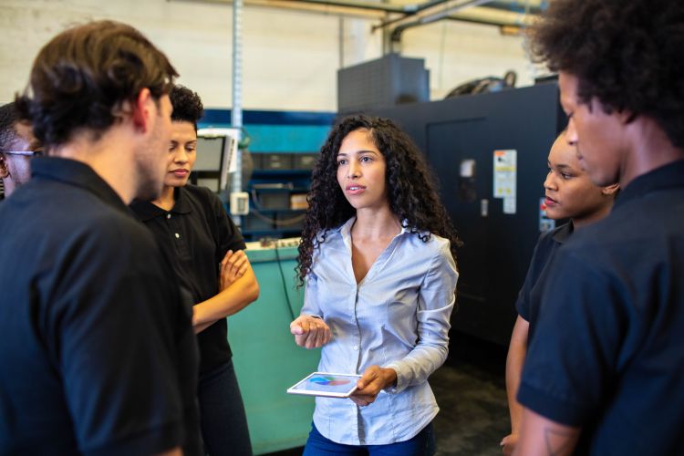 woman speaking to a group at work