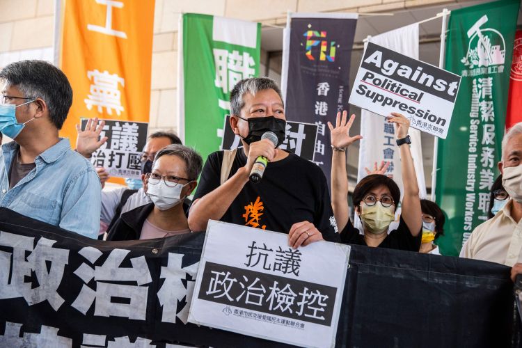 Pro-democracy activist Lee Cheuk-yan (C) speaks to the media next to former lawmaker Cyd Ho (centre L) outside West Kowloon Court in Hong Kong on April 1, 2021