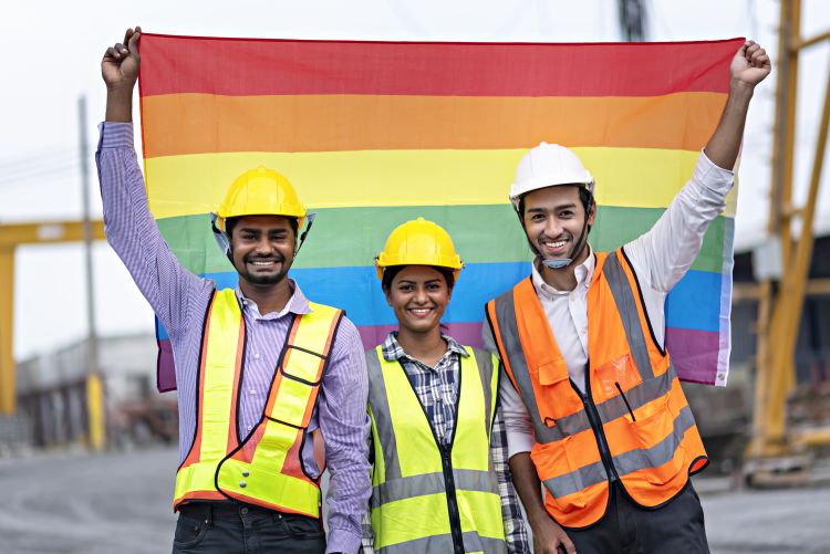 Construction workers are holding rainbow flag to celebrate gender equality