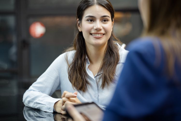 A new female employee on a job interview final round with an HR officer in a business office