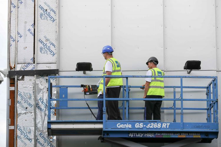 Workers remove cladding for testing from one of the tower blocks in Salford City on June 26, 2017 in Salford, England.