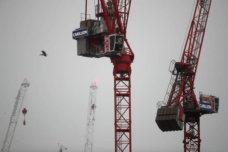 Cranes against a grey skyline, with Carillion logo