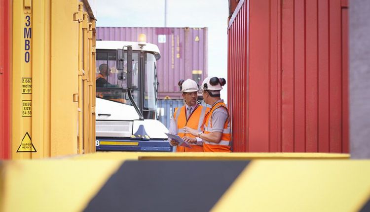 Workers at container port. Photo: Monty Rakusen