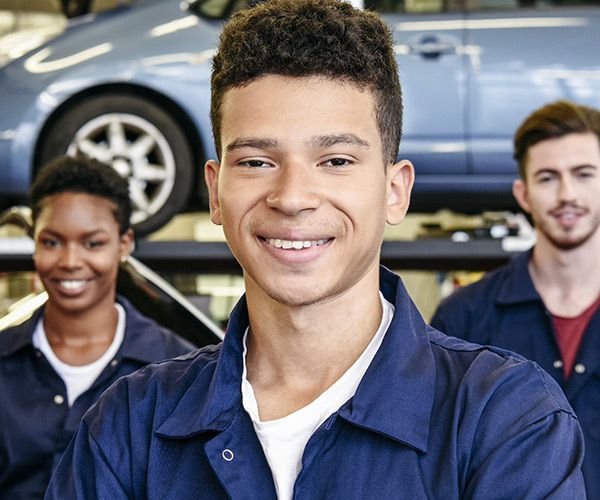 Young mechanics in garage. Photo: Johnny Greig