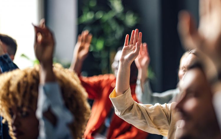 group of raised hands