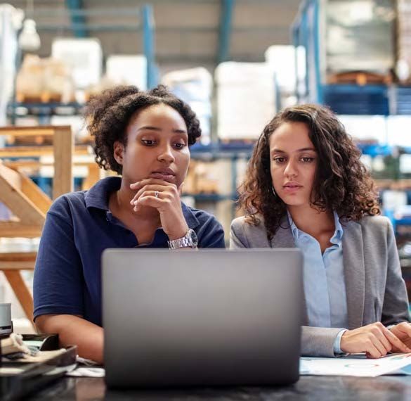 Photo: workers looking at laptop screen