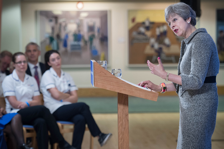 Image of Theresa May delivering a speech at a hospital
