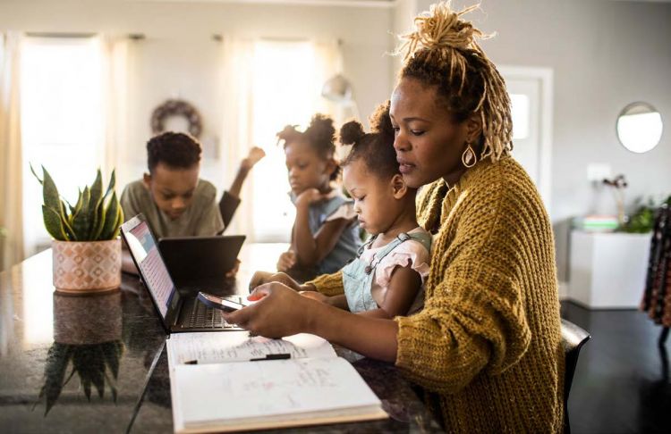 Photo: Mother with her children while working from home.