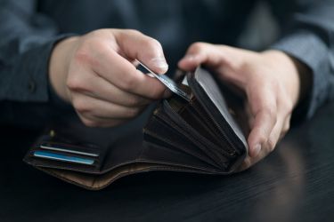 Person putting credit cards into a wallet