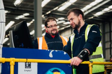 Two men working on machinery