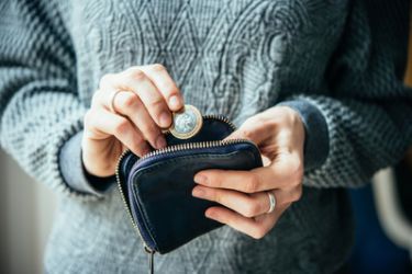 Woman putting change into purse