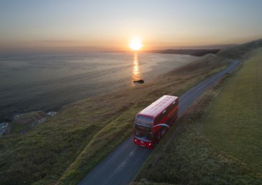 Bus driving down coast