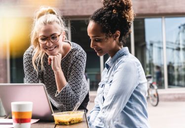 Two young women working outside