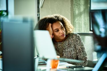 Woman looking stressed at desk