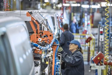 Female worker on vehicle production line in car factory