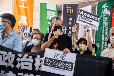 Pro-democracy activist Lee Cheuk-yan (C) speaks to the media next to former lawmaker Cyd Ho (centre L) outside West Kowloon Court in Hong Kong on April 1, 2021