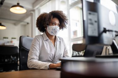 Woman wearing a face mask at an office.
