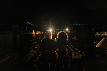 Rear view of female stage performers performing on stage at amateur theatre