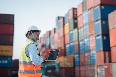 Male engineer working at containers yard