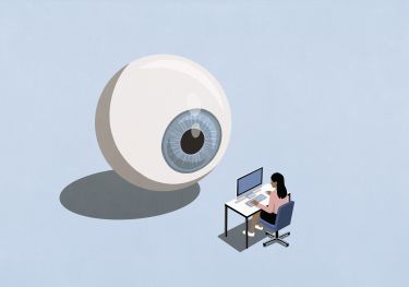 Large blue eyeball watching businesswoman working at computer 