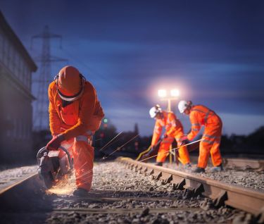 three railway workers at night