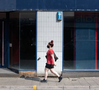 Woman walking past shop