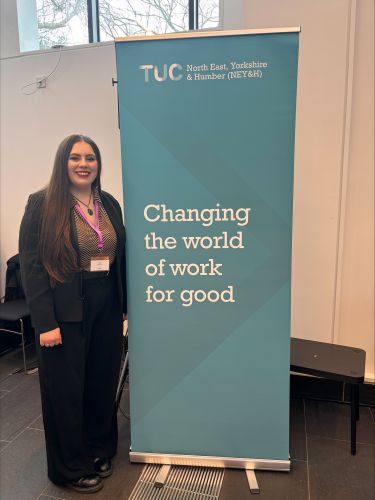 Rosie standing alongside a TUC NEY&H banner