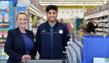 Two young retail workers smiling at the camera