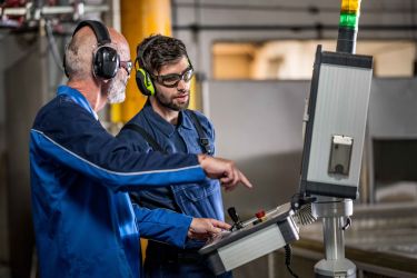 Senior CNC Waterjet Operator Instructs Young Apprentice