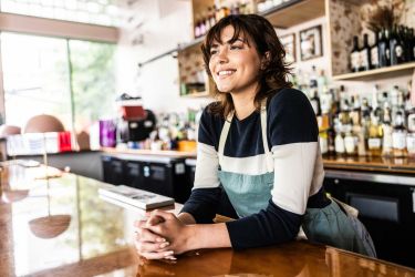 Young female restaurant manager talking inventory with digital tablet